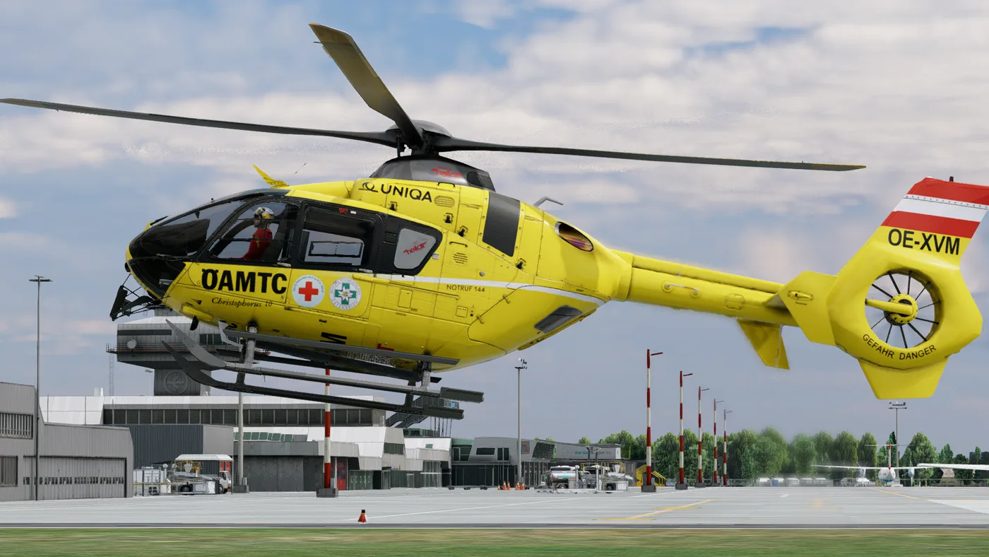 Gelber Notarzthubschrauber Christophorus 10 im Schwebeflug über dem Vorfeld